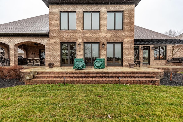 1225 Chloe Dr, Gallatin, TN 37066 - back of property featuring a shingled roof, french doors, a yard, a patio area, and brick siding