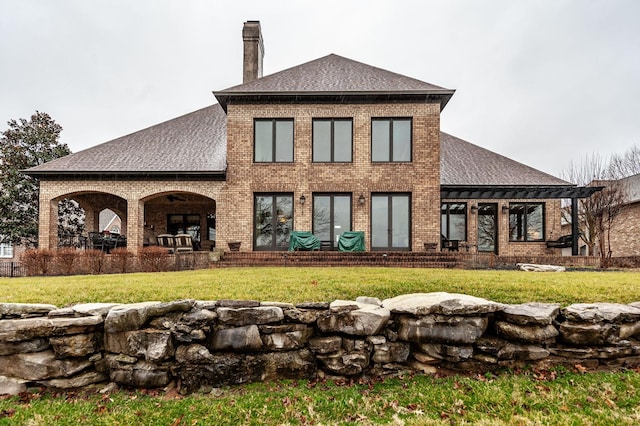 1225 Chloe Dr, Gallatin, TN 37066 - rear view of house with a shingled roof, a lawn, and a chimney