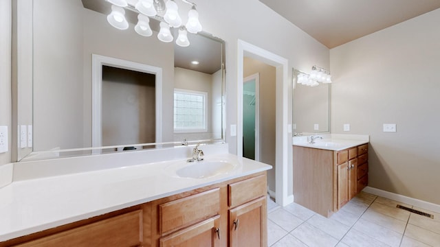 bathroom featuring two vanities, tile patterned flooring, a sink, and visible vents