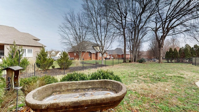 view of yard with a residential view and fence