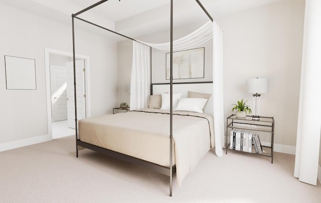 carpeted bedroom with baseboards and ensuite bathroom