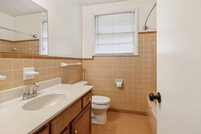 full bath featuring toilet, tile patterned flooring, tile walls, and vanity