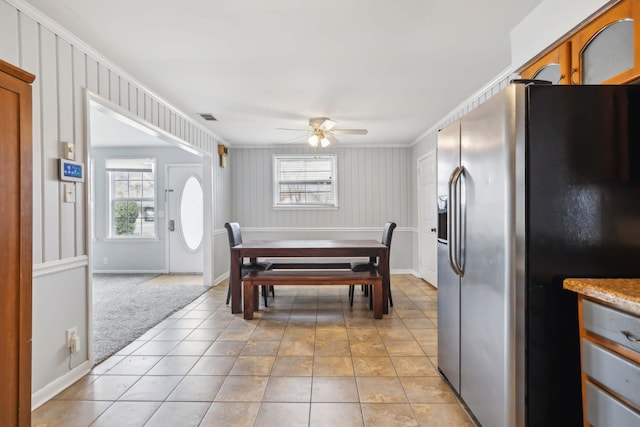 dining space with light tile patterned floors, baseboards, visible vents, and a ceiling fan