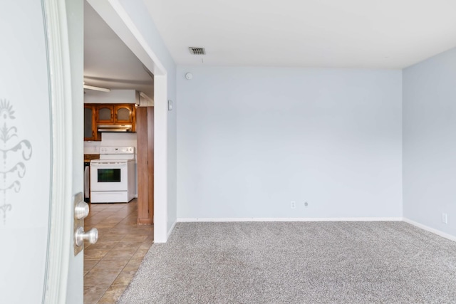 spare room featuring light tile patterned floors, baseboards, visible vents, and light colored carpet