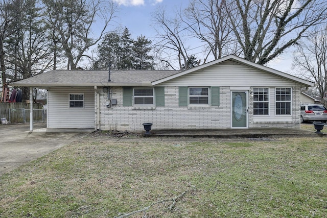 ranch-style home featuring a front yard, fence, and brick siding