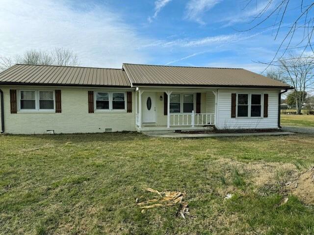 ranch-style house with covered porch, metal roof, crawl space, and a front yard