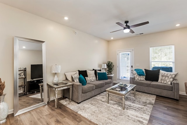 living room featuring a ceiling fan, visible vents, wood finished floors, and recessed lighting