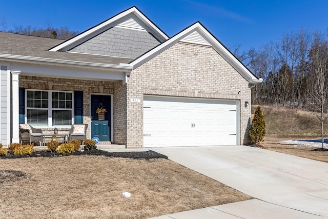 view of front facade with a garage, a shingled roof, concrete driveway, covered porch, and brick siding