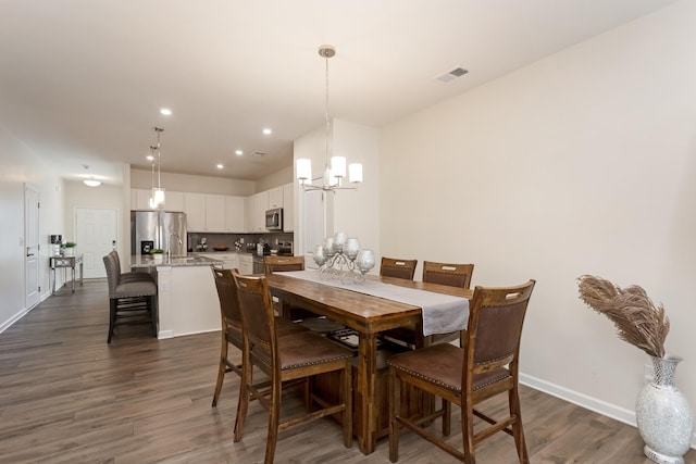 dining room with recessed lighting, a notable chandelier, visible vents, baseboards, and dark wood-style floors