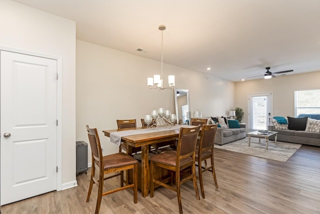 dining space featuring recessed lighting, baseboards, visible vents, wood finished floors, and ceiling fan with notable chandelier