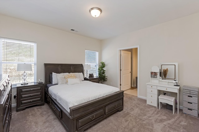 bedroom with light carpet and visible vents