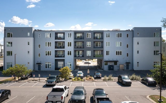 view of building exterior with uncovered parking