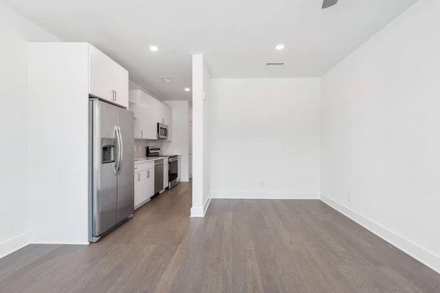 kitchen featuring light wood-style flooring, stainless steel appliances, visible vents, white cabinetry, and light countertops