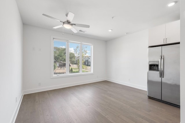 empty room with ceiling fan, recessed lighting, wood finished floors, visible vents, and baseboards