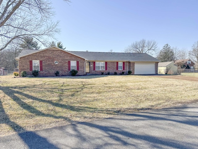 ranch-style house with a garage, a front yard, brick siding, and driveway