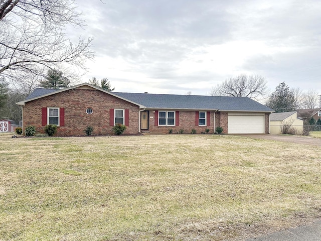 ranch-style home featuring driveway, brick siding, a front lawn, and an attached garage