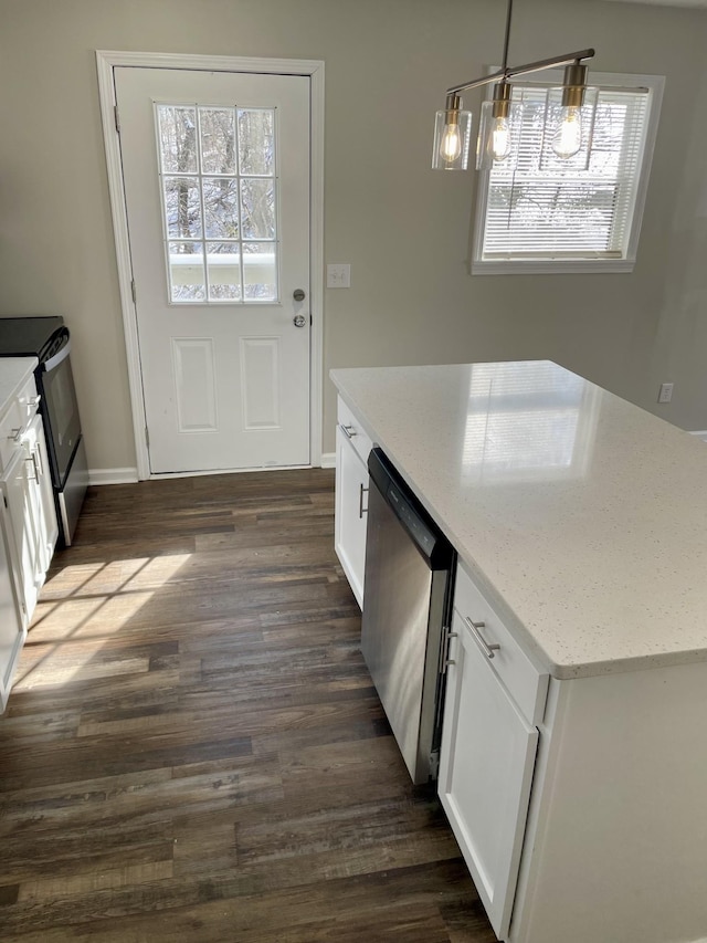 kitchen featuring light stone counters, dark wood-style floors, pendant lighting, appliances with stainless steel finishes, and white cabinets