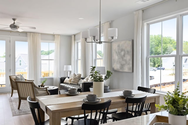 dining space with light wood-style floors and a ceiling fan