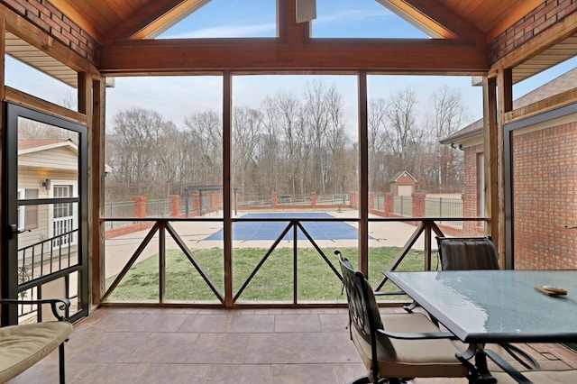 unfurnished sunroom featuring a wealth of natural light, wooden ceiling, and vaulted ceiling