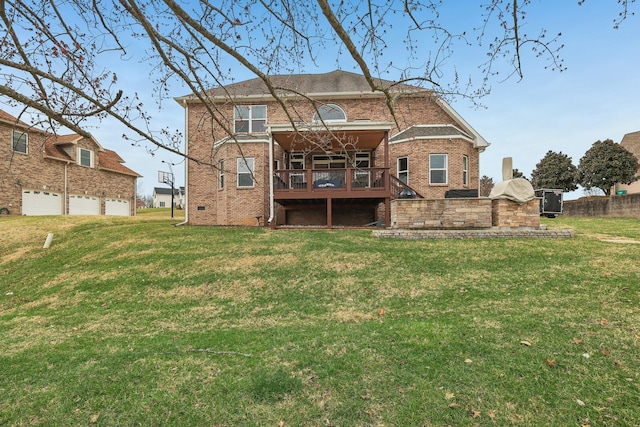 rear view of house with a garage, crawl space, brick siding, and a yard