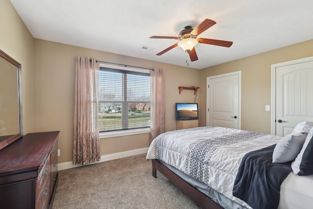 bedroom with light carpet, visible vents, baseboards, and ceiling fan