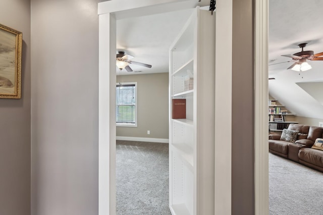 corridor with light carpet and baseboards