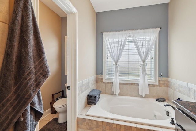 bathroom featuring toilet, tile patterned flooring, and a bath