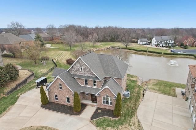 drone / aerial view with a water view and a residential view