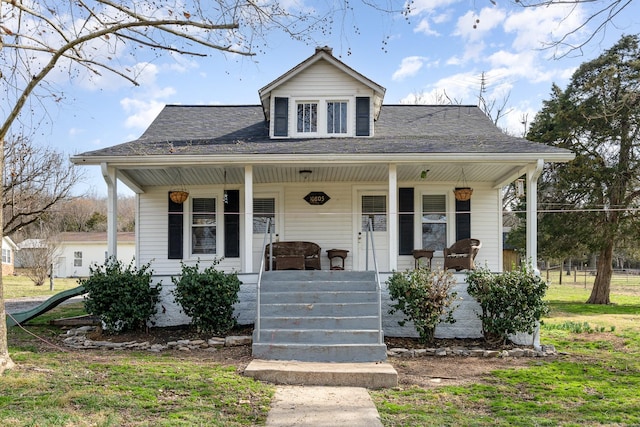 bungalow-style house featuring covered porch and a shingled roof