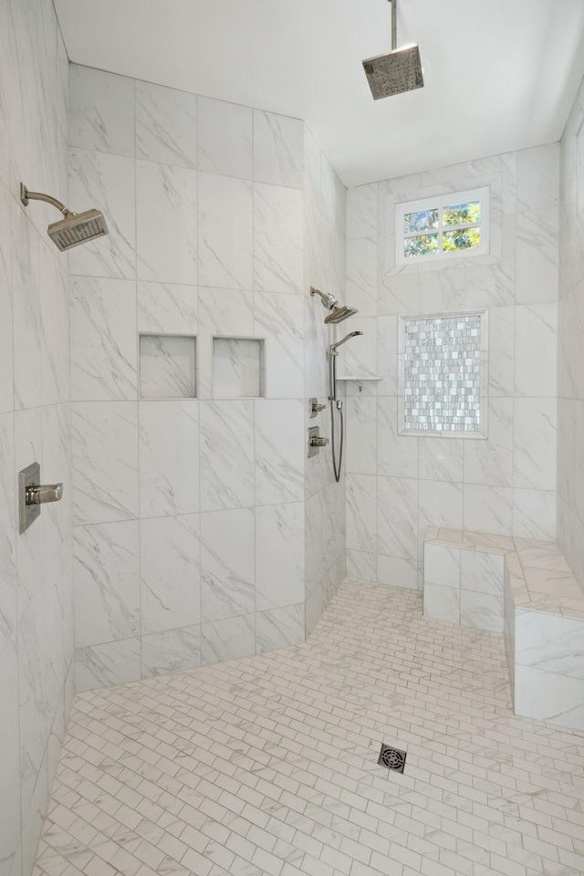 bathroom featuring a tile shower