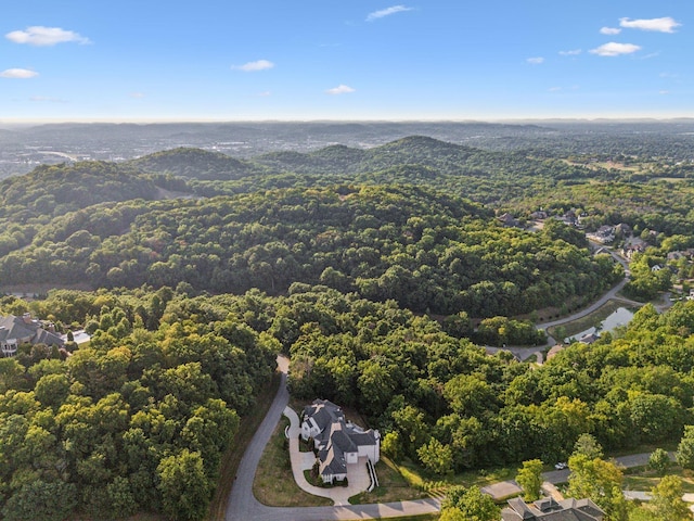 birds eye view of property featuring a wooded view