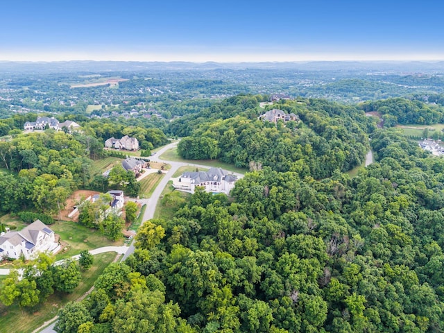 drone / aerial view featuring a forest view