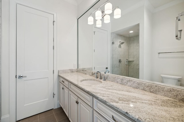 bathroom featuring toilet, tile patterned flooring, a shower stall, and vanity