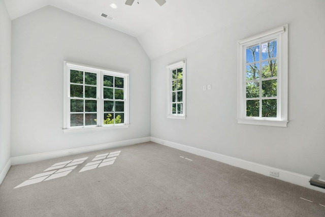 spare room with vaulted ceiling, visible vents, and plenty of natural light