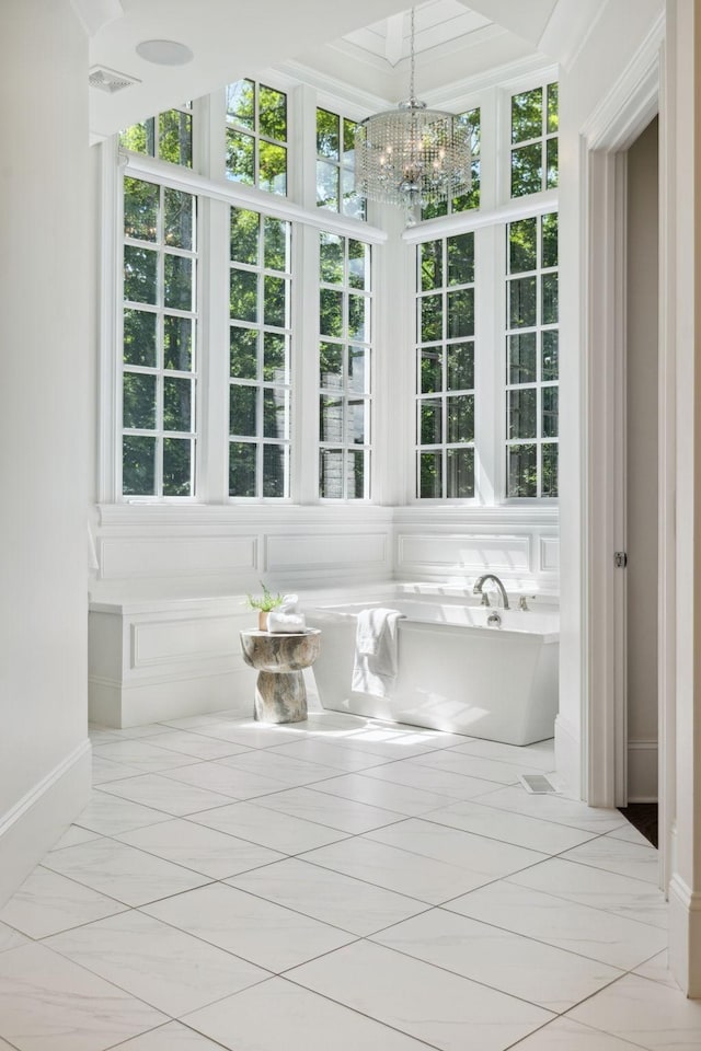 bathroom with a freestanding tub and a chandelier