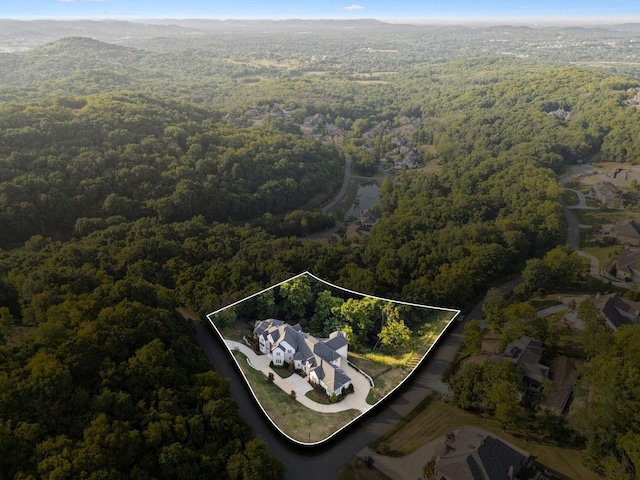 drone / aerial view featuring a forest view