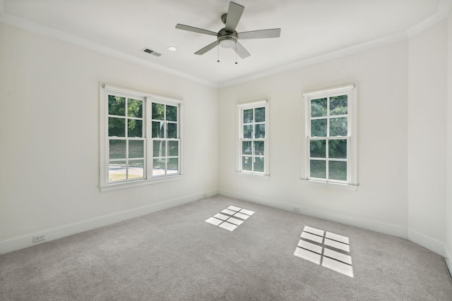 spare room featuring ornamental molding, visible vents, and light colored carpet