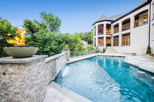 outdoor pool featuring fence