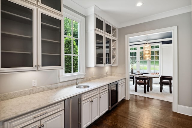 kitchen with dark wood-style floors, wine cooler, light countertops, white cabinets, and a sink