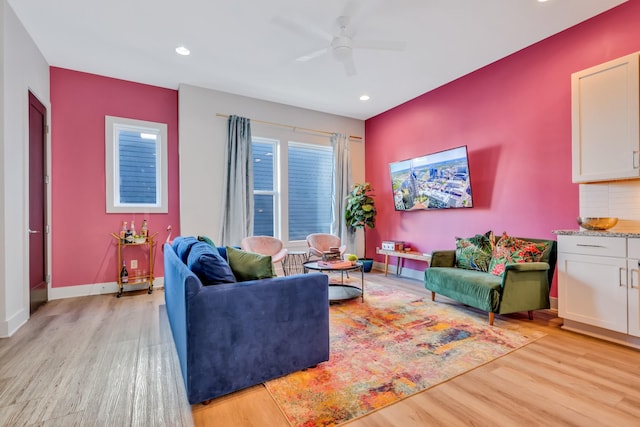 living room with baseboards, recessed lighting, a ceiling fan, and light wood-style floors