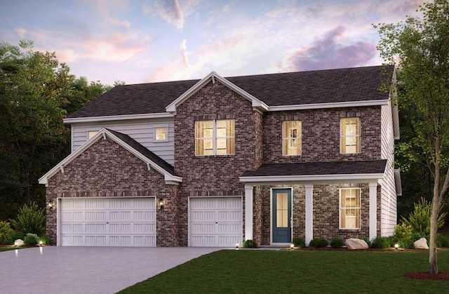 view of front of property featuring brick siding, a lawn, a garage, and driveway