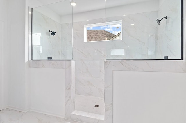 bathroom featuring marble finish floor and a marble finish shower