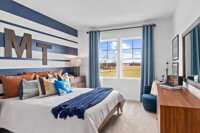 carpeted bedroom featuring baseboards