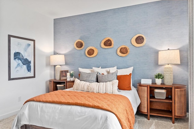 bedroom featuring baseboards and light colored carpet