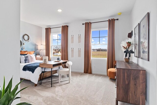 bedroom featuring light carpet, baseboards, and recessed lighting