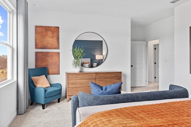 bedroom with light carpet, visible vents, and baseboards