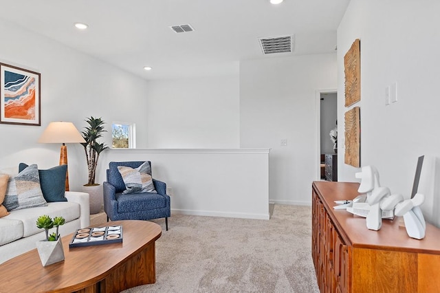 living area featuring baseboards, recessed lighting, visible vents, and light colored carpet