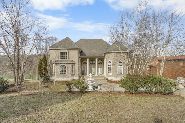 view of front of house featuring a front yard and stucco siding