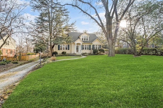 view of front facade featuring a front yard, fence, and stucco siding