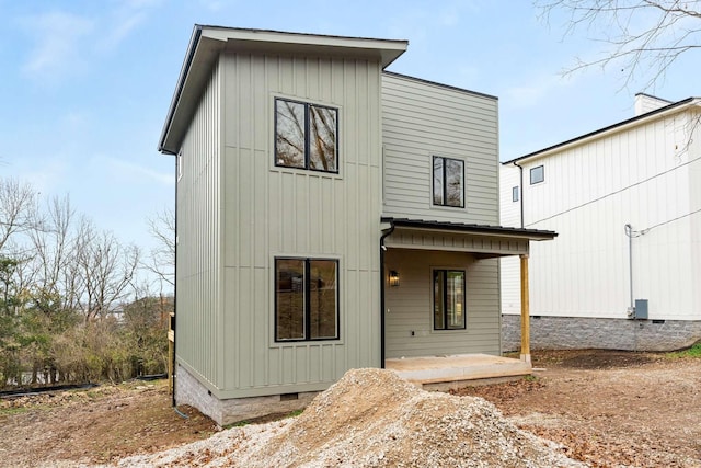 back of property with a patio and crawl space